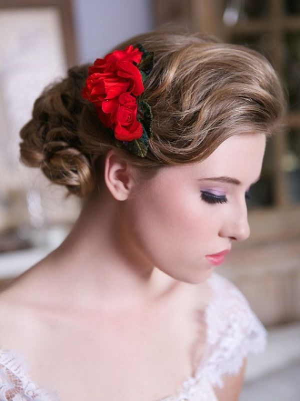 A red flower headpiece with leaves is a nice accessory to accent your winter bridal hairstyle