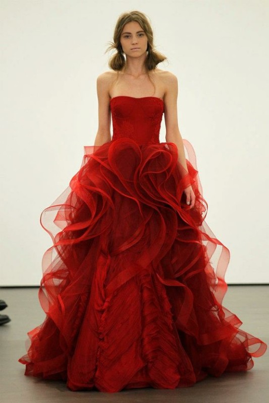 A strapless red A line wedding dress with a ruffled skirt of layers is a stylish idea for a modern winter wedding