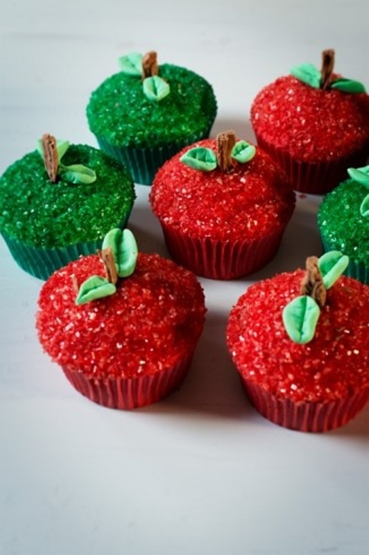 Red and green cupcakes covered with glitter and with edible leaves on top are amazing for a winter or Christmas wedding