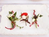 cool green, white and red boutonnieres with leaves, pinecones, cotton and wood slices and bright ribbons