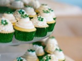 cupcakes with frosting and green sugar flowers on top plus green liners are great for a winter or Christmas wedding