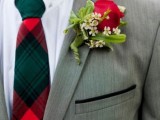 a plaid green and red tie plus a red rose boutonniere for accessorizing a winter or Christmas groom’s look