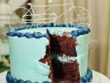 a light blue wedding cake with nautical sugar patterns and a wire bike topper is a stylish idea for a spring wedding