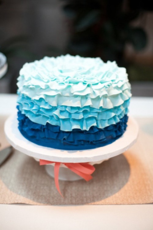 a ruffle ombre wedding cake from aqua to navy is a bold and cool idea for a wedding done in a blue color palette