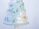 a serenity blue wedding cake with sugar botanical patterns and blooms is a lovely idea for a spring or summer wedding