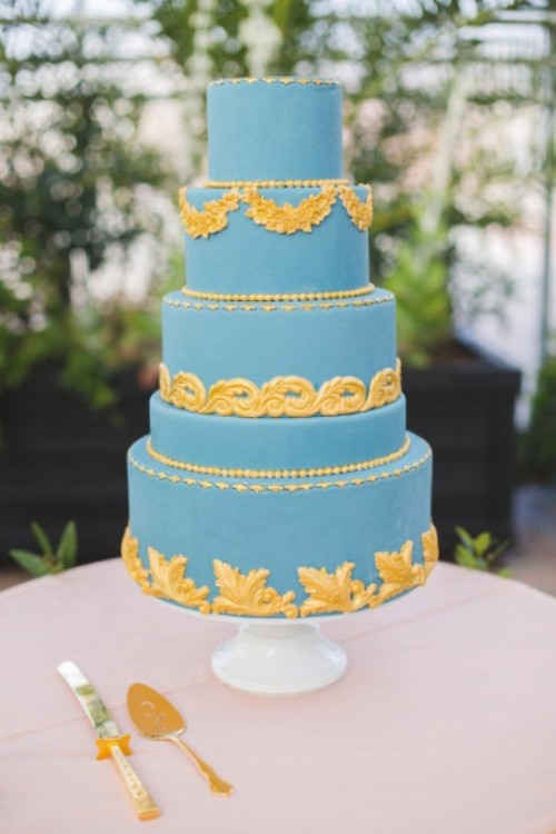 a light blue wedding cake with beautiful and refined vintage gold patterns is ideal for a beautiful vintage-inspired wedding