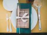 a plywood menu accented with a wheat spike and a ribbon bow is a lovely decoration for a place setting