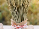 a burlap sack with wheat and a lace bow is a pretty rustic decoration for a fall wedding, use it anywhere