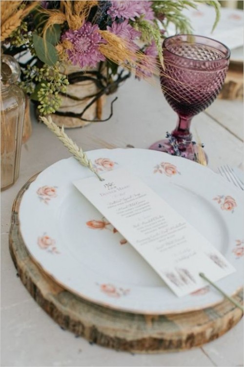 a wheat spike holding the menu in place on a place setting is a pretty and cool idea for a rustic summer or fall wedding