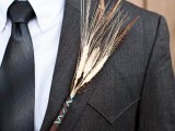 a beautiful and simple fall wedding boutonniere of feathers and wheat is ideal for the fall