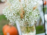 a rustic arrangement with baby’s breath and wheat to accent a wedding aisle or your wedding reception table