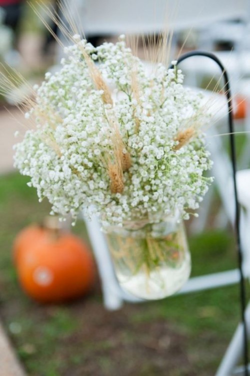 a rustic arrangement with baby's breath and wheat to accent a wedding aisle or your wedding reception table