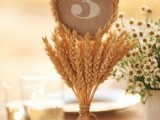 a wheat arrangement holding a burlap and wheat table number will be a pretty idea for a summer or fall rustic wedding