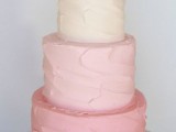 an ombre light pink textural wedding cake topped with a gold heart is a beautiful idea for a spring wedding