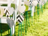 printed paper and felt hearts on sticks are great to line up the aisle, this is a budget-friendly alternative to blooms