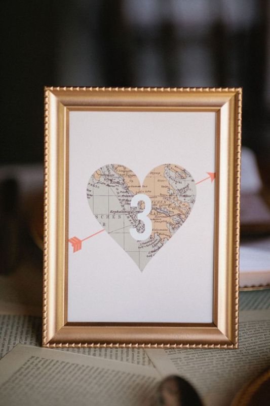 a heart map table number in a gold frame is a cool solution for a traveler wedding and it's easy to make