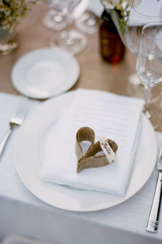 a burlap heart with a name is a cool place card holder for a rustic wedding and you can DIY it