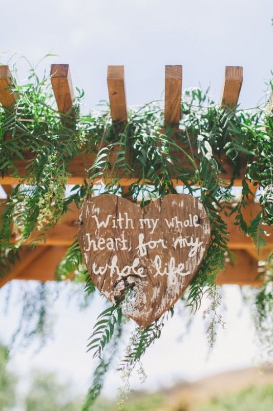 a plywood heart with a quote is a lovely rustic wedding decor idea you can DIY easily