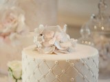 a white textural wedding cake with white sugar blooms is a beautiful and elegant dessert