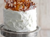 a textural white buttercream wedding cake topped with caramel splashes for a modern wedding