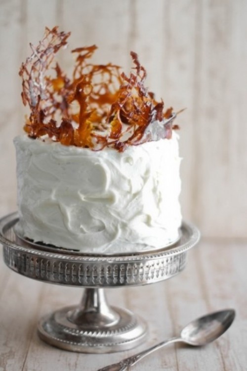 a textural white buttercream wedding cake topped with caramel splashes for a modern wedding