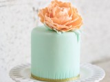 a mint one tier wedding cake topped with a coral sugar bloom is a bright and bold option for a spring or summer wedding