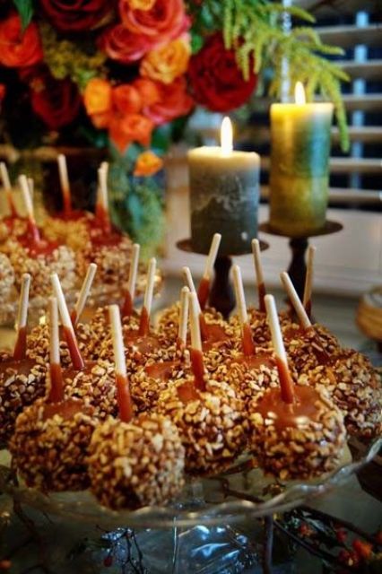 caramelized apples on sticks covered with nuts are amazing wedding desserts or wedding favors