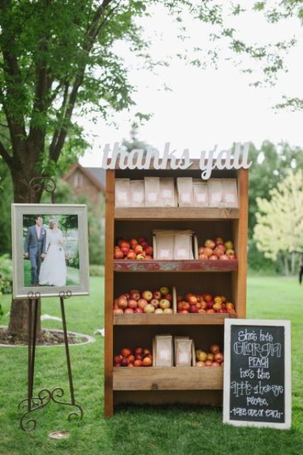 a wooden storage unit with calligraphy and apples plus a chalkboard sign is a great piece to give your apples as wedding favors