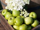a crate with green apples and white hydrangeas is a lovely wedding decoration or you may offer these apples as desserts
