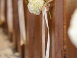 white silk ribbon securing white hydrangeas and accenting the aisle seats are nice for many types of weddings