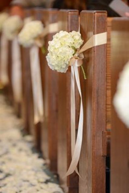 white silk ribbon securing white hydrangeas and accenting the aisle seats are nice for many types of weddings