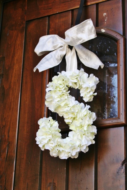 a neutral floral monogram with a silk ribbon bow is a lovely decoration for your wedding venue