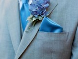 a blue silk tie and handkerchief plus a bold blue boutonniere are a nice solution for accenting a groom’s look