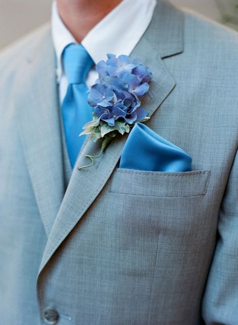 a blue silk tie and handkerchief plus a bold blue boutonniere are a nice solution for accenting a groom's look