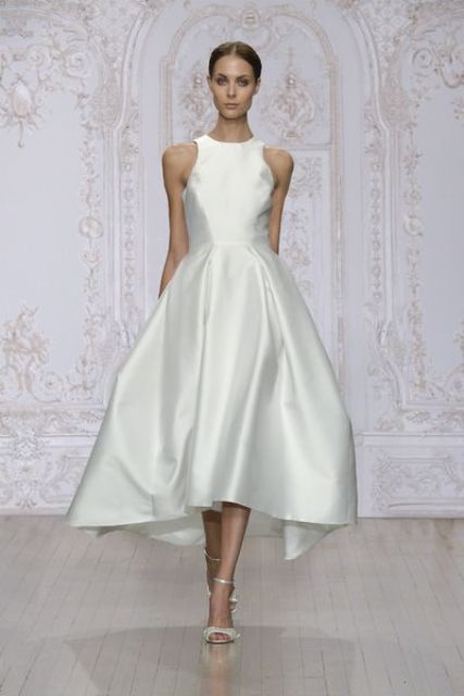 an A-line midi silk wedding dress with a halter neckline and a full skirt is a lovely idea for a modern or minimalist wedding