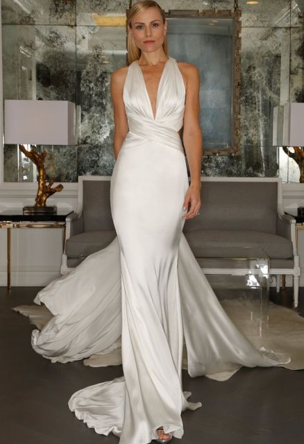 a fitting silk wedding dress with a draped bodice and a cutout neckline, a long train is a chic and refined idea for a modern wedding