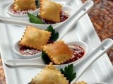 large spoons with tomato sauce and meat or ricotta ravioli is a non-traditional appetizer idea