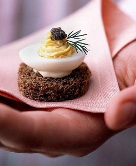 a mini crostini with cream cheese, an egg, some sauce and a blackberry on top is a very whimsy fall idea