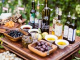 an olive oil tasting bar with various kinds of olives, olive oil, nuts, some bread and cheese is perfect for a Tuscany wedding