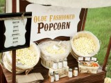 a simple and retro popcorn bar styled with various toppings is a cool idea for any wedding, not only a retro one
