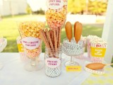 pop corn and dog corn plus pretzel bar in big jars and boxes is a cool idea of a wedding food bar
