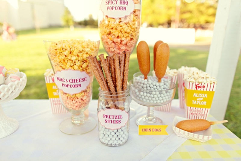 Pop corn and dog corn plus pretzel bar in big jars and boxes is a cool idea of a wedding food bar