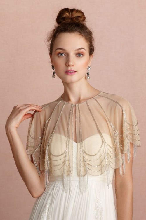a beautiful nude sheer embellished cape with embellishments and embellished fringe is very refined