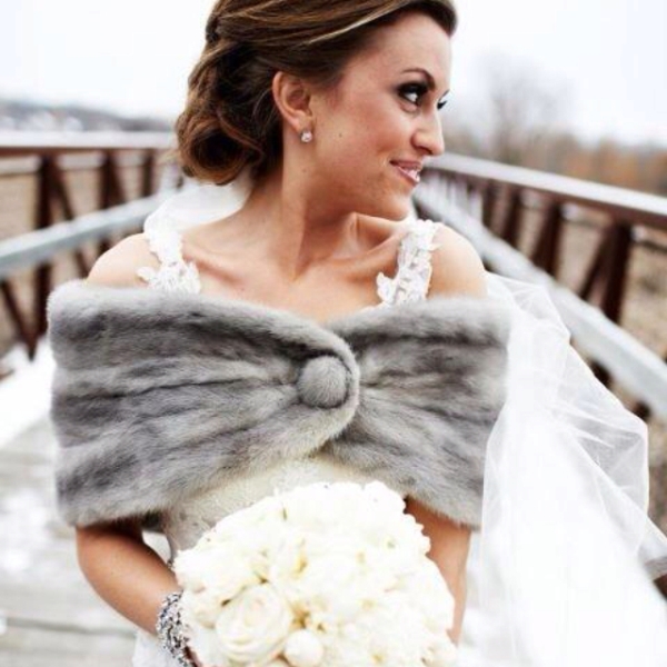 A grey faux fur coverup with a button is a great piece to pair it with a sleeveless or strapless wedding dress
