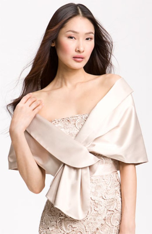 A neutral plain coverup of shiny fabric is a cool idea for a bride who loves vintage