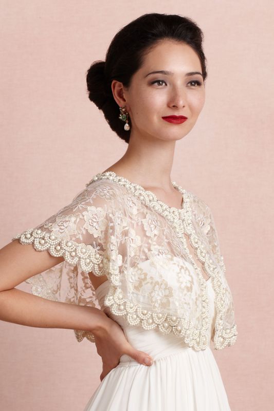 A beaded lace capelet on a button is a chic idea to add vintage elegance to your bridal look