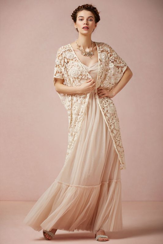 A long sleeveless lace coverup in a creamy shade is a boho touch to your fall bridal look
