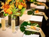 a bright tropical wedding tablescape with bold blooms, tropical leaf chargers, neutral linens and white menus is stylish and chic
