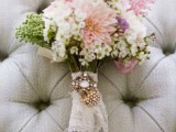 a lace wrap with a rhinestone brooch is an amazing accent for a vintage-inspired wedding bouquet
