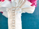 a white bouquet wrap with buttons and with hoops is a chic and refined idea for a chic wedding bouquet